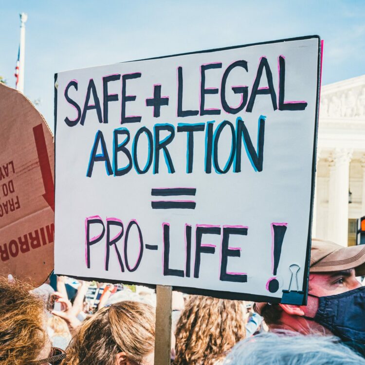 Safe and legal abortion equals pro-life sign at protest in front of the Capitol